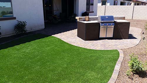 built-in BBQ Bar pavers synthetic grass. Small backyard desert landscape
